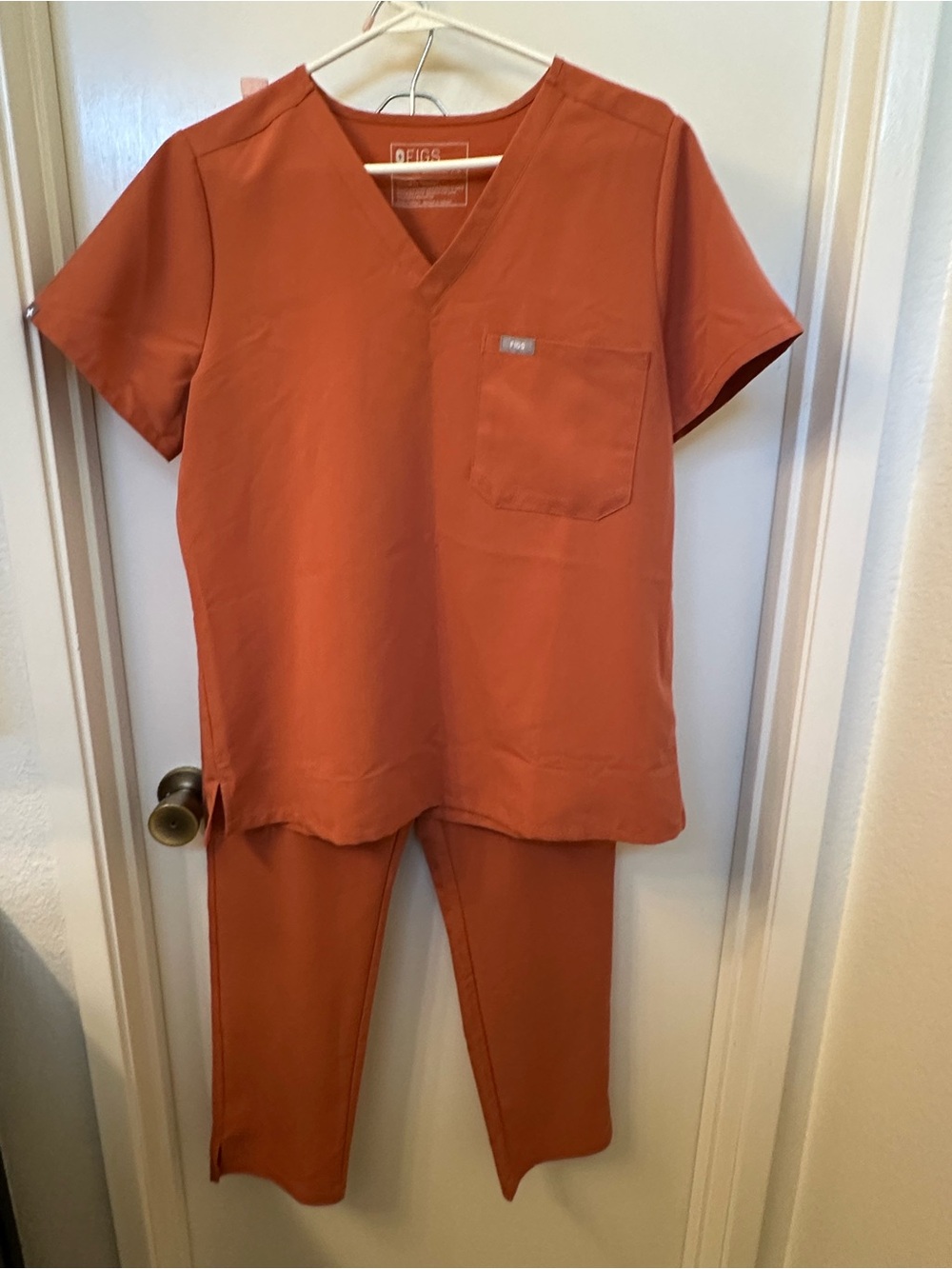 FIGS Women’s V-Neck Scrub Top and Pants in Rust Orange